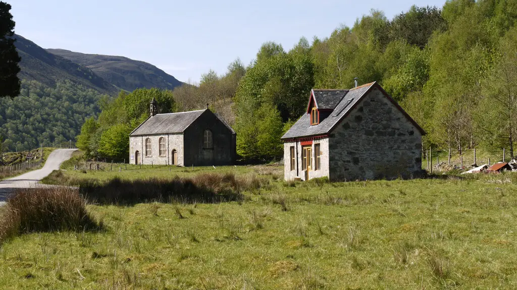 Image showing a disused church and renovated cottage